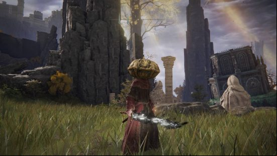 Elden Ring spells - a robed character stands in the grass holding a blade covered in black flames.