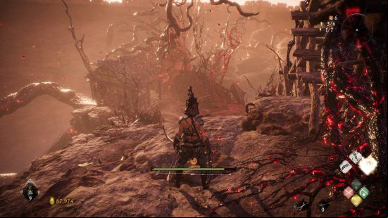 Wo Long Dragon's Vein Crystals Essences - the player looks down a slope at a house covered in corrupted vines. A chest is inside containing the essence.