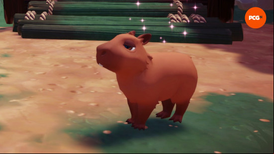 A sleepy-looking brown Dreamlight Valley Capybara looks ahead having been fed by the player.