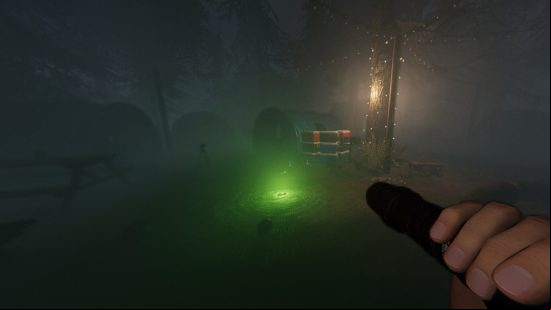 Phasmophobia Ascension update - A player holds up a torch towards a glowing green device on the ground.
