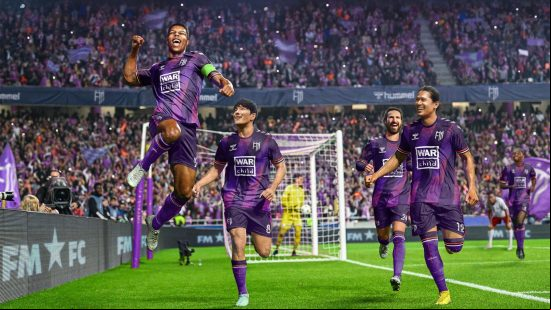 Best sports games: a group of football players celebrate after scoring a goal.