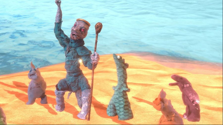 Judero - several handcrafted figures stand on a beach.