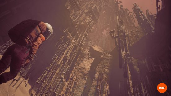 An astronaut in The Invincible looking up at a wide metal landscape.