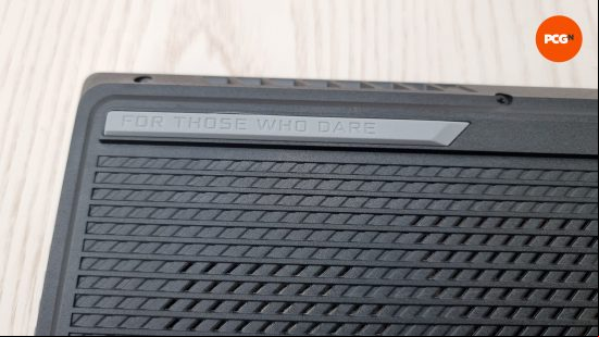 The underside of the Asus ROG Strix Scar 17 (2023), featuring the ROG motto of 'For Those Who Dare'