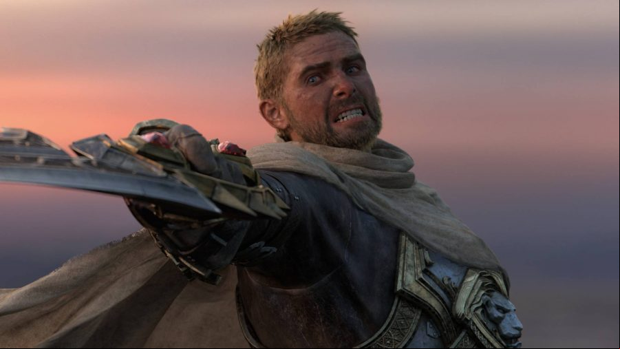 World of Warcraft: A blond, unkempt man grits his teeth, raising a broken sword at the camera as dusk falls behind him
