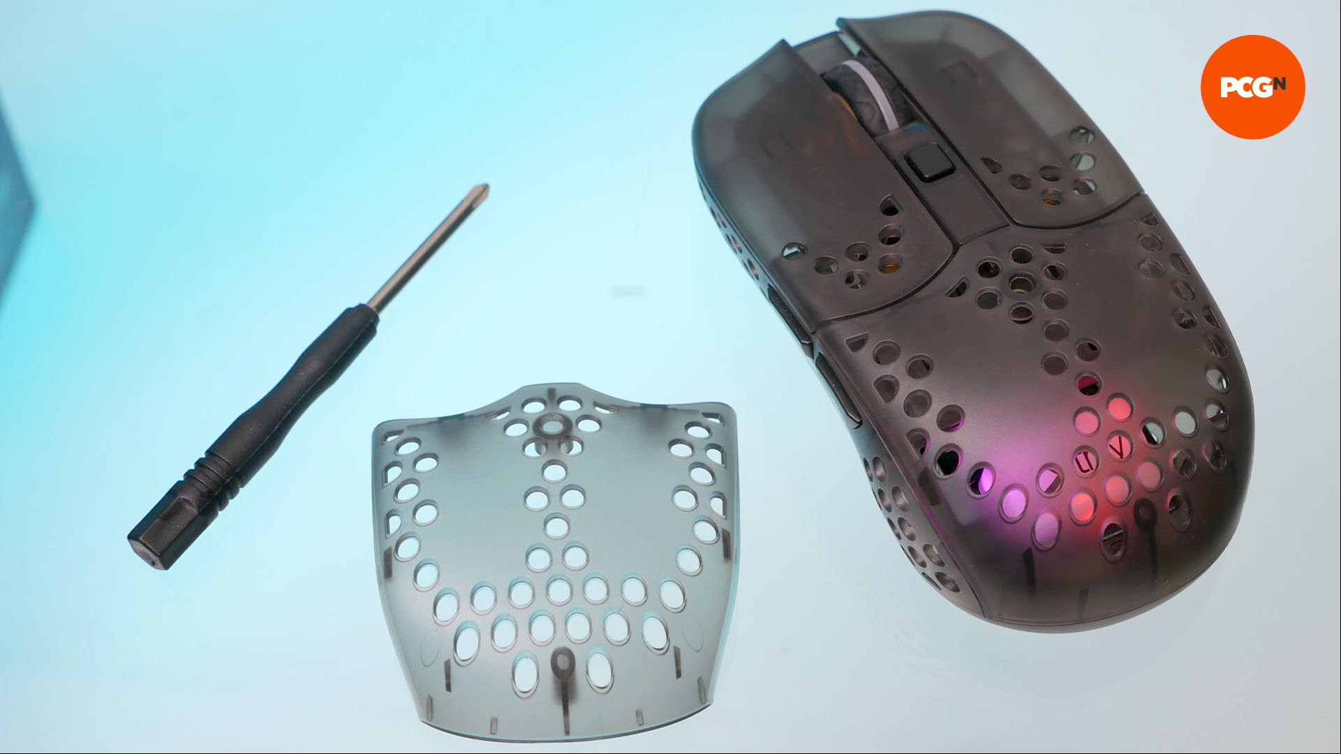 A spare top plate of the cherry xtrfy MZ1 wireless mouse along with a screwdriver