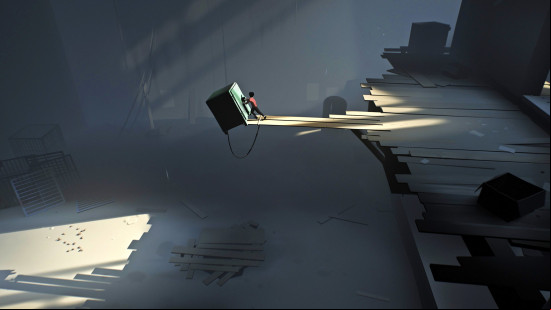 A young boy pushes an enormous safe onto a pit covered by wooden planks in Inside, one of the best platform games.