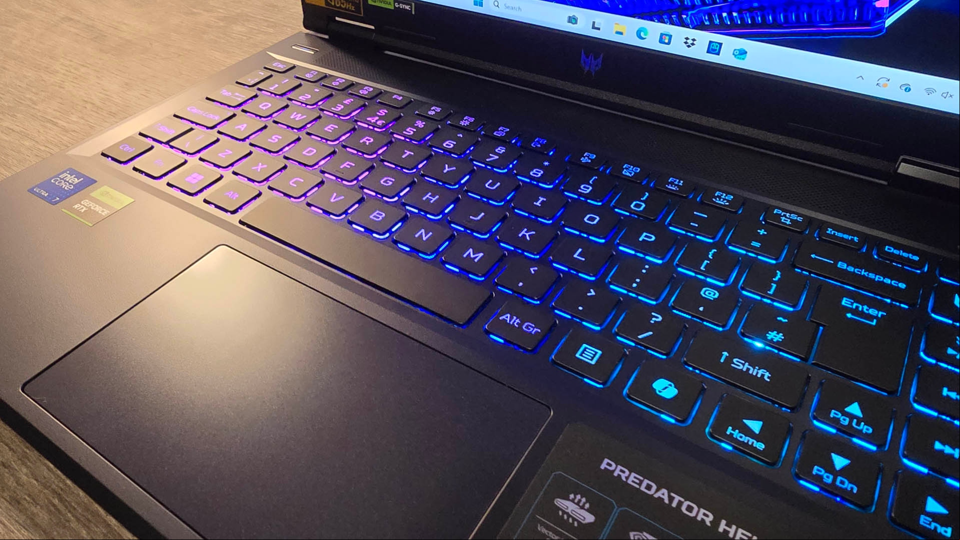 Acer Predator Helios Neo 14 review image showing the keyboard with the RGB lights switched on.