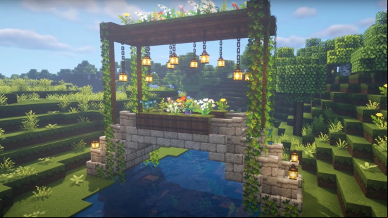 Aa pretty stone Minecraft bridge with a floral roof and a flower bed in either railing.