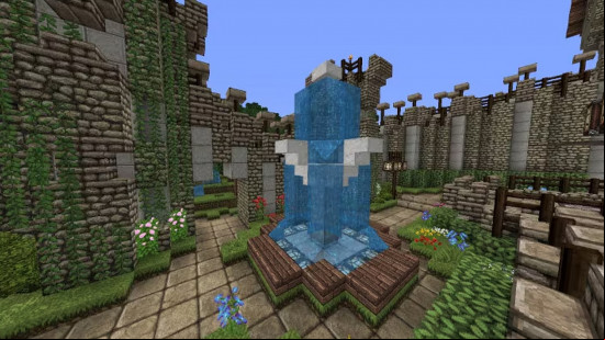 A fountain inside the walled courtyard of a Minecraft castle build.