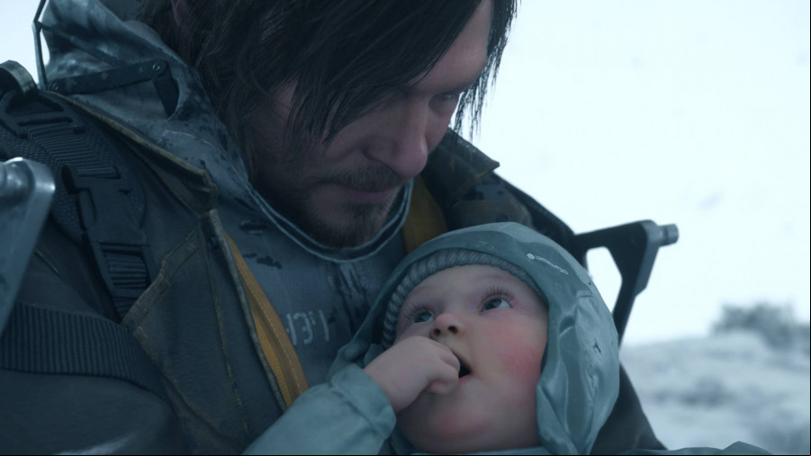 Death Stranding 2: A man wearing a space suit with messy brown hair looks down at a baby wearing a warm hat