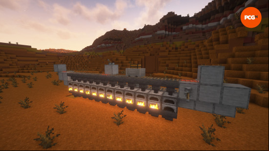 Minecraft farms: A 12-furnace auto smelter working at dusk in the Badlands.