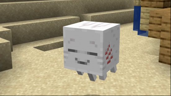 A happy little Minecraft Ghastling floats above sand in the overworld.