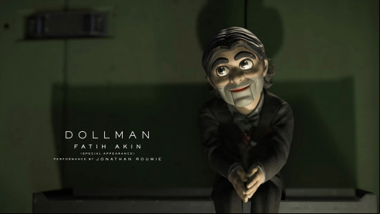 Death Stranding 2 voice actors: a doll in a black suit, with big bushy eyebrows