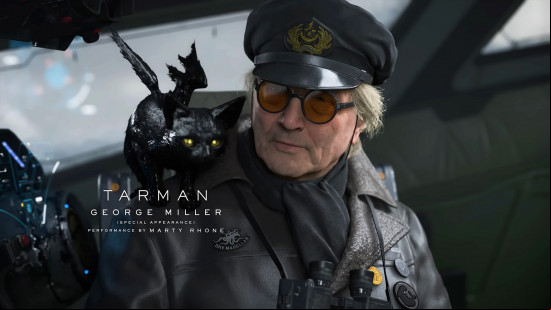 Death Stranding 2 voice actors: a blonde man wearing a black uniform with a small black cat on his shoulder